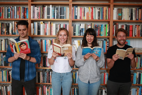 gif of clique team holding books they purchased