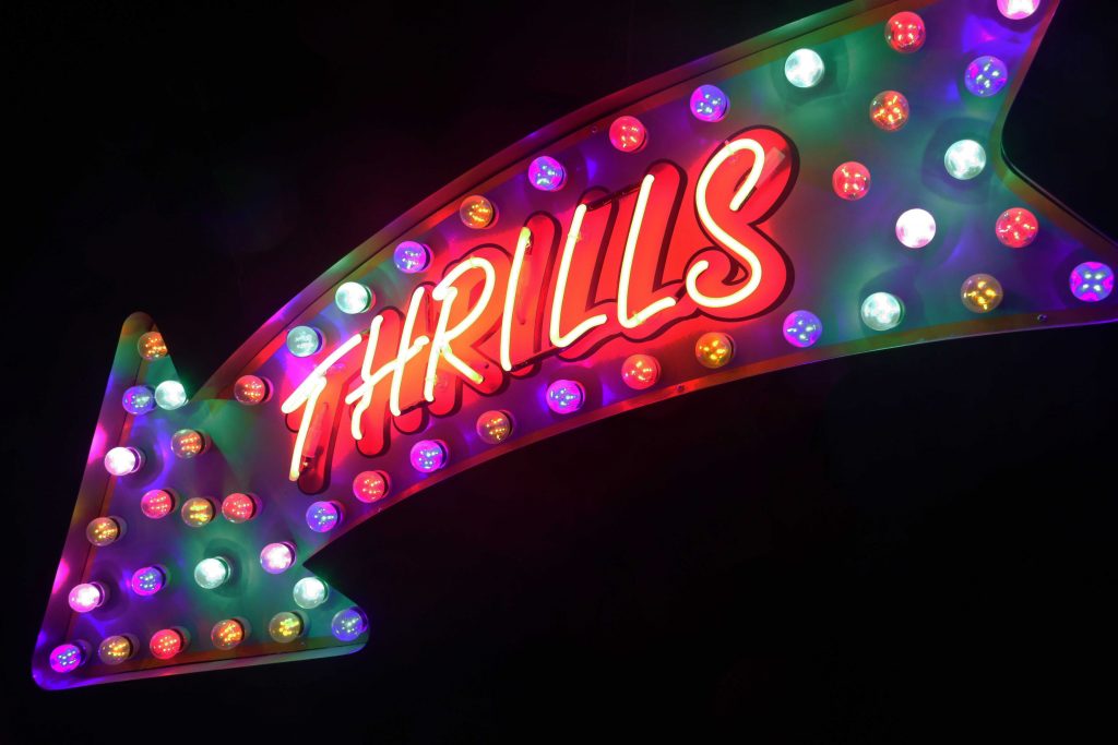 Neon sign saying "Thrills"