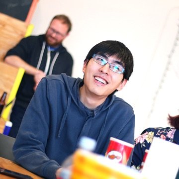 Designer smiling at a group meeting