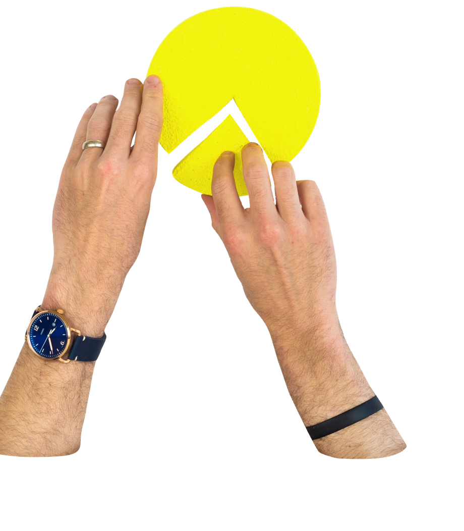 Hands putting together a pie chart with a missing piece