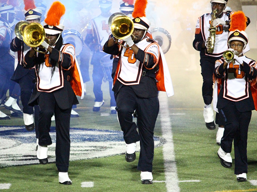 Tumpet players marching on field